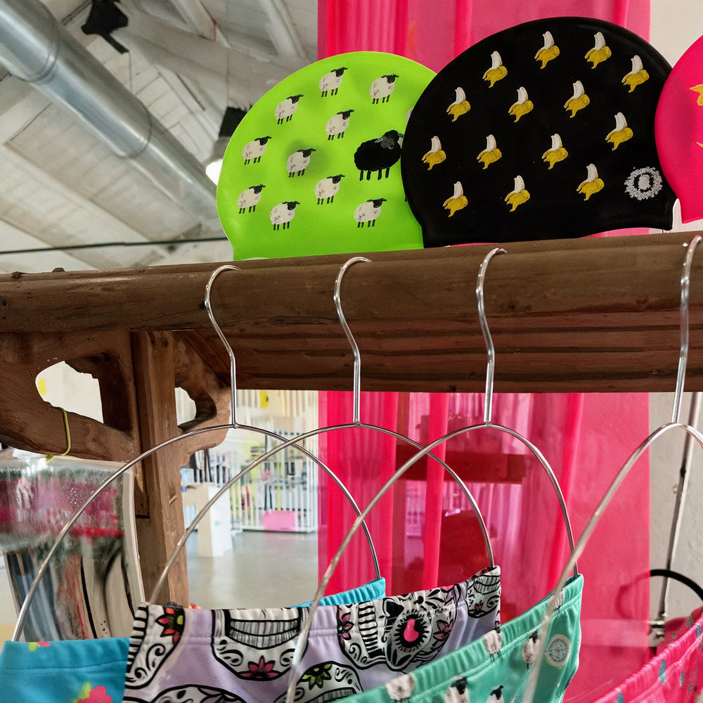 Fluo swim caps and printed swimsuits on the shop shelves